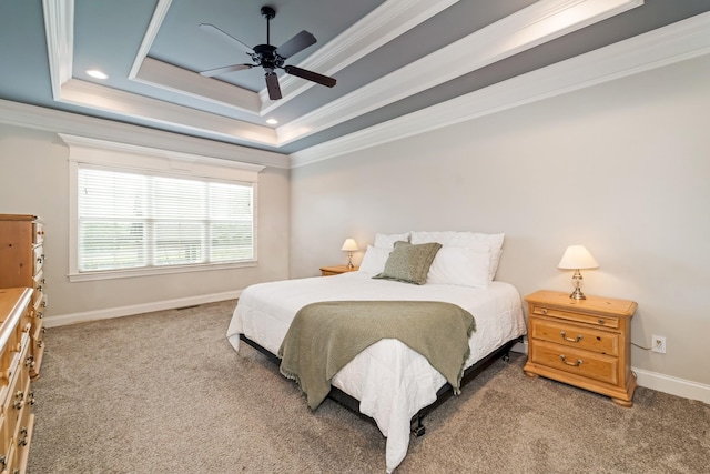 bedroom featuring carpet floors, a tray ceiling, ceiling fan, and crown molding