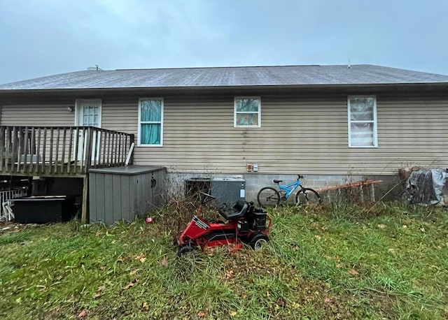 rear view of house featuring central AC and a deck