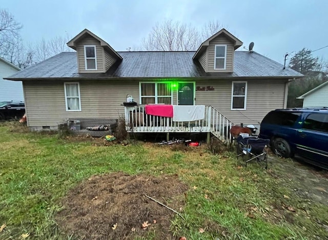 rear view of house with a yard and a deck