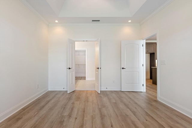 unfurnished bedroom featuring light hardwood / wood-style floors and crown molding