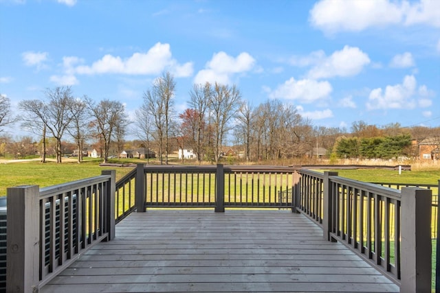 wooden deck featuring a yard