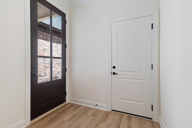 entryway featuring light hardwood / wood-style floors and ornamental molding