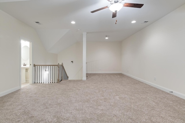 additional living space featuring ceiling fan, light colored carpet, and vaulted ceiling