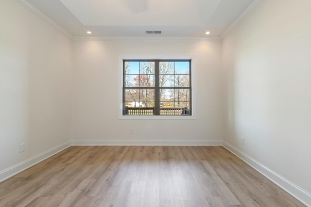 spare room featuring light hardwood / wood-style floors and ornamental molding