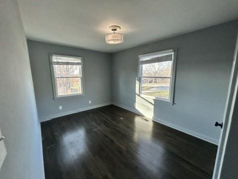 spare room with dark wood-type flooring