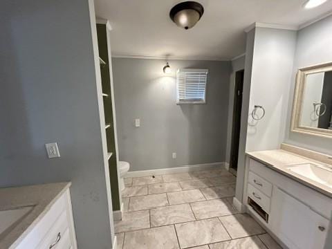 bathroom with tile patterned flooring, vanity, toilet, and crown molding