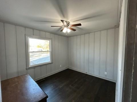 spare room with ceiling fan and dark hardwood / wood-style floors