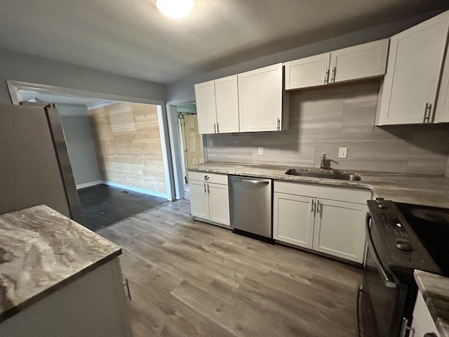 kitchen featuring light hardwood / wood-style floors, white cabinetry, sink, and appliances with stainless steel finishes