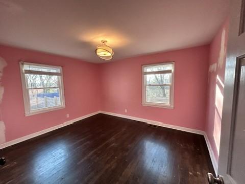 spare room featuring dark wood-type flooring