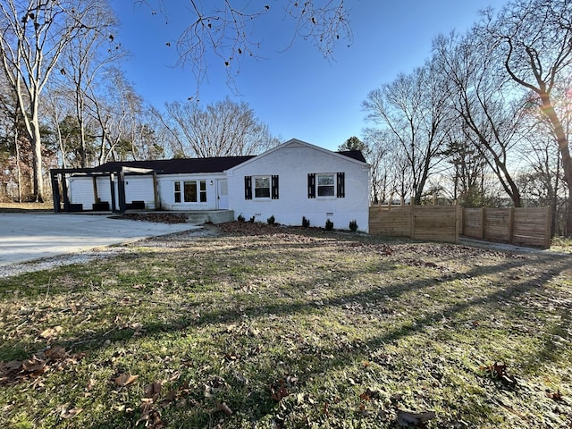 view of front of home featuring fence and brick siding