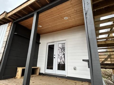 doorway to property featuring french doors and a wooden deck