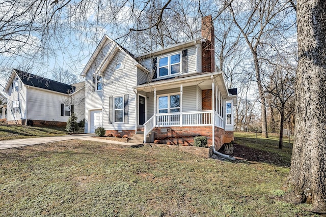 view of front property featuring covered porch, a garage, and a front yard