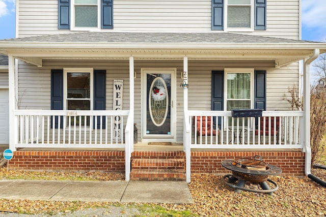 view of exterior entry with covered porch