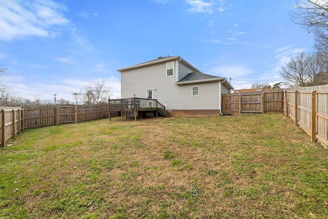 rear view of property featuring a deck and a lawn