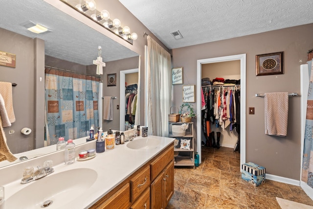 bathroom featuring vanity and a textured ceiling