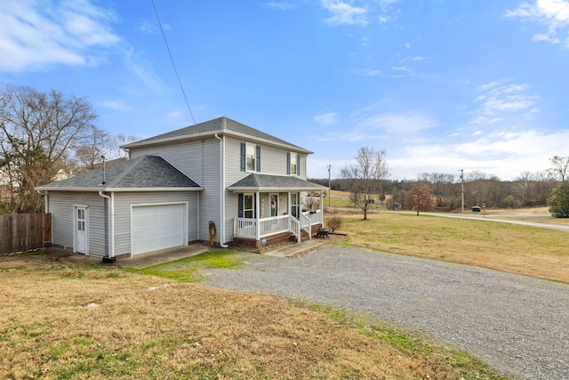 view of front facade with a front lawn, covered porch, and a garage