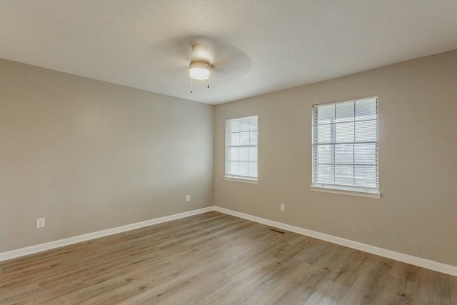 spare room featuring light hardwood / wood-style floors and ceiling fan