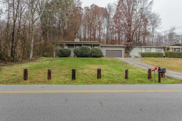 ranch-style house with a garage and a front lawn