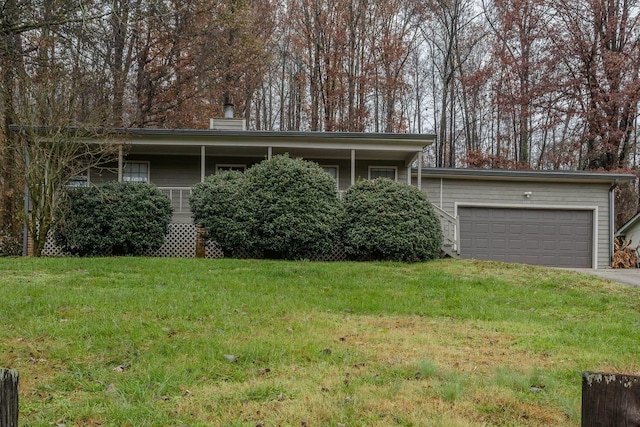 ranch-style house featuring a garage and a front yard