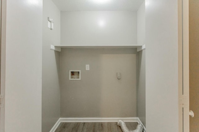 washroom featuring hookup for an electric dryer, washer hookup, a textured ceiling, and hardwood / wood-style flooring