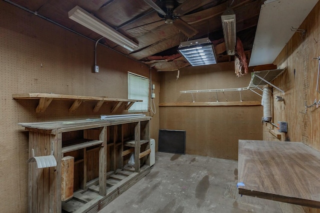 basement featuring a workshop area and ceiling fan