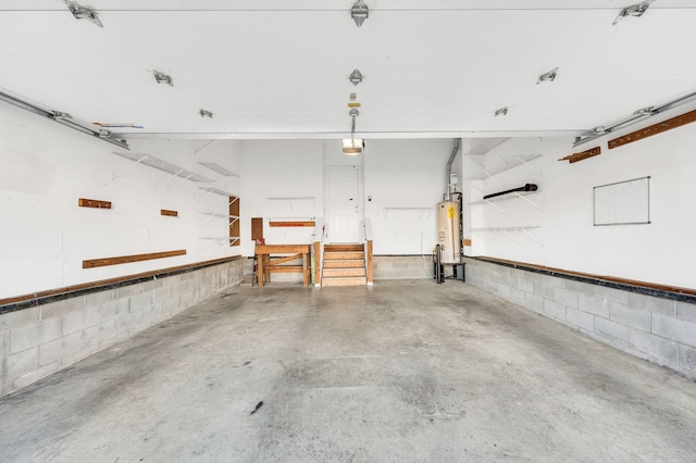 garage featuring water heater and a garage door opener