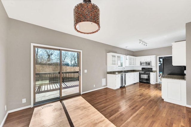 kitchen with white cabinetry, sink, decorative light fixtures, decorative backsplash, and appliances with stainless steel finishes