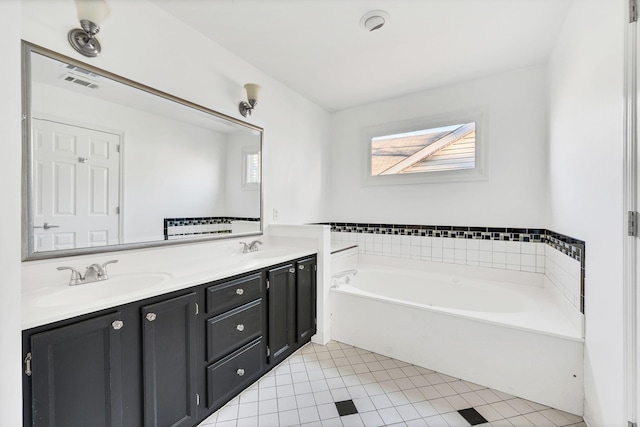 bathroom featuring tile patterned floors, a bathing tub, and vanity