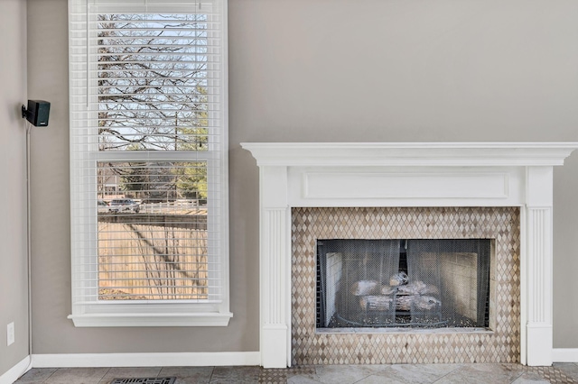 details with a tiled fireplace