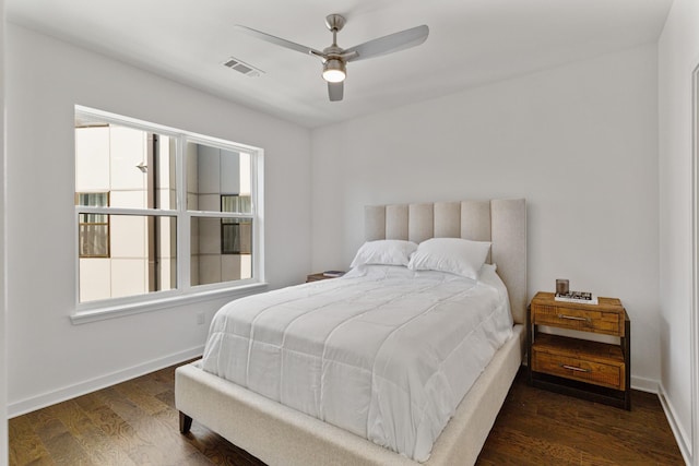 bedroom with ceiling fan and dark hardwood / wood-style flooring