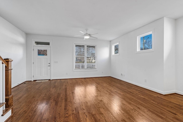 unfurnished living room with ceiling fan and dark wood-type flooring