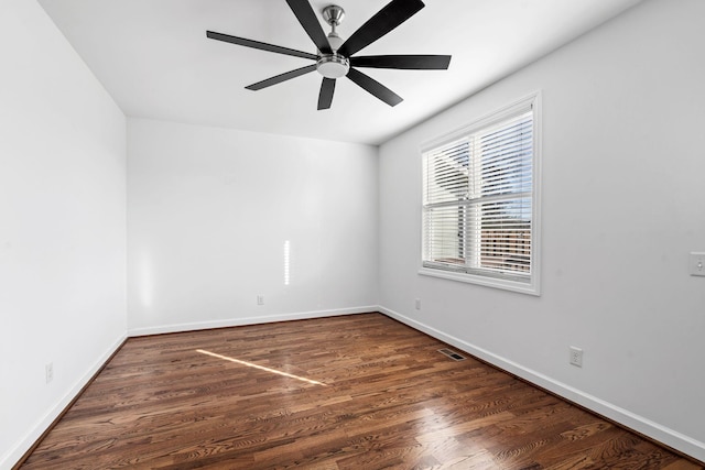 unfurnished room with dark hardwood / wood-style flooring and ceiling fan