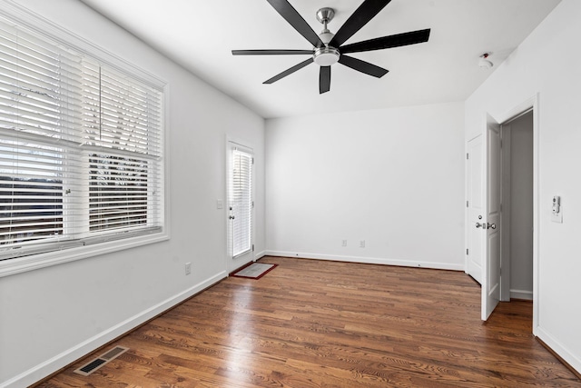 unfurnished room featuring ceiling fan and dark wood-type flooring