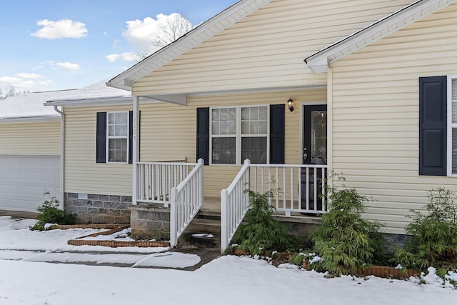 view of snow covered property entrance