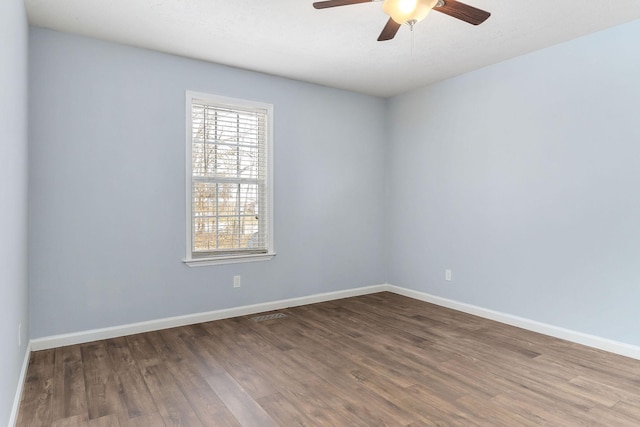 spare room with ceiling fan and dark hardwood / wood-style floors