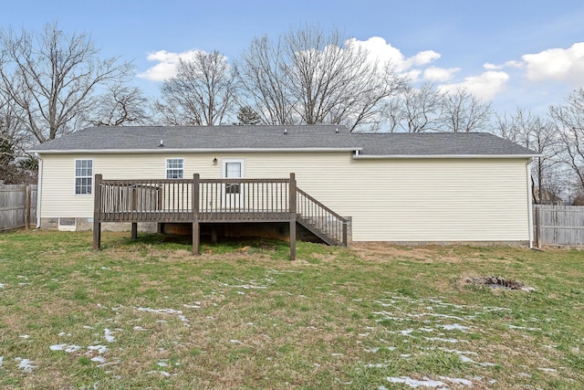 back of house featuring a yard and a deck