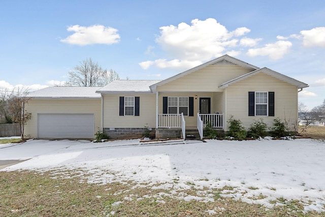 ranch-style house featuring covered porch and a garage