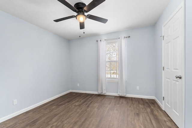 unfurnished room featuring dark hardwood / wood-style flooring and ceiling fan