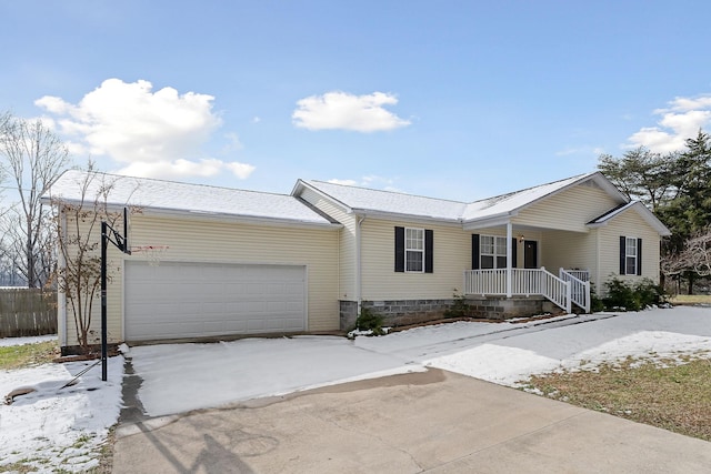 ranch-style house with covered porch and a garage