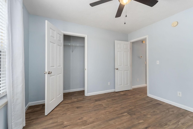 unfurnished bedroom featuring dark hardwood / wood-style flooring, a closet, and ceiling fan