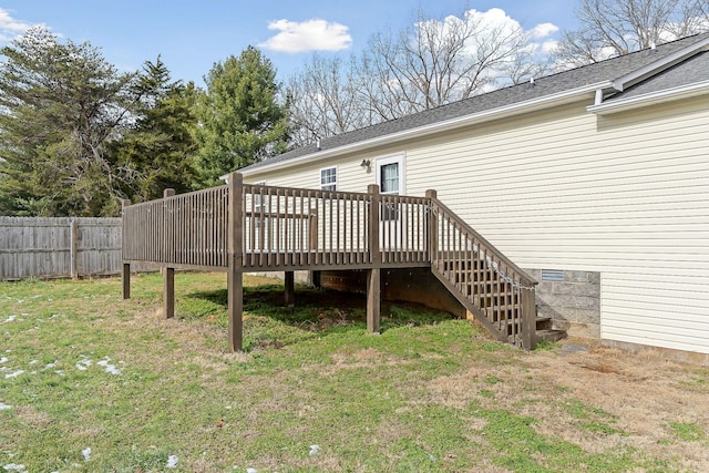 back of property with a lawn and a wooden deck