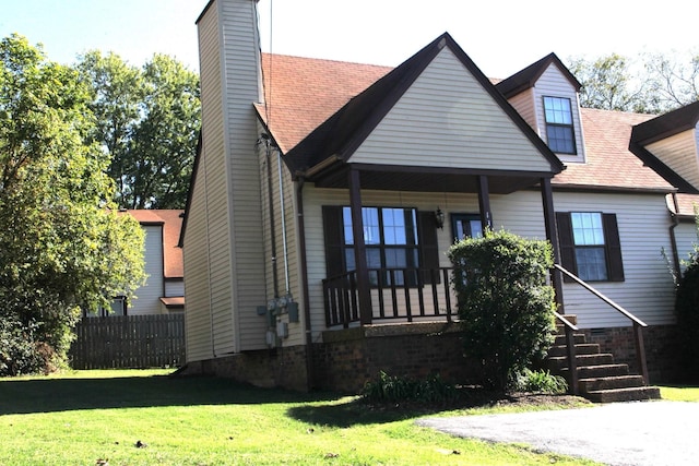 view of front of house featuring a front yard and covered porch