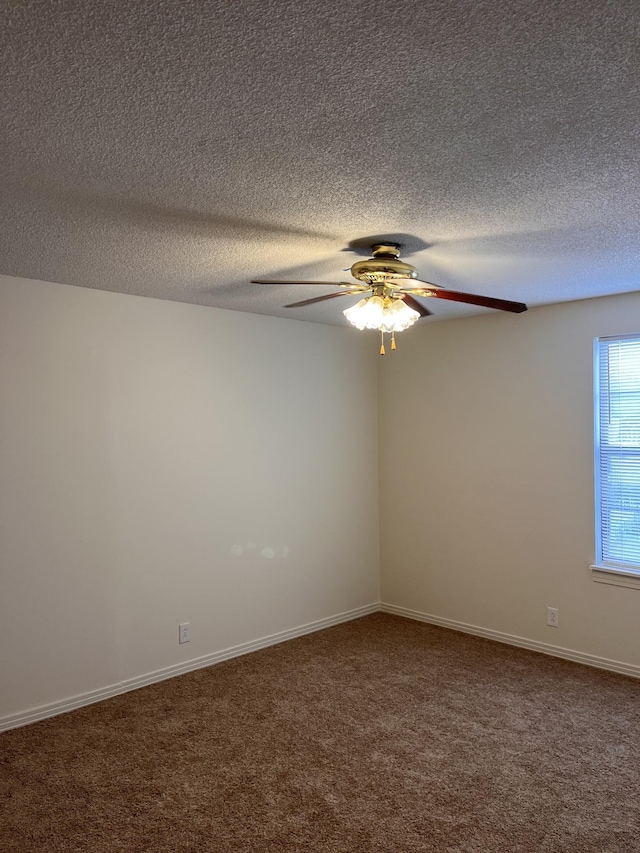 spare room featuring ceiling fan and carpet flooring