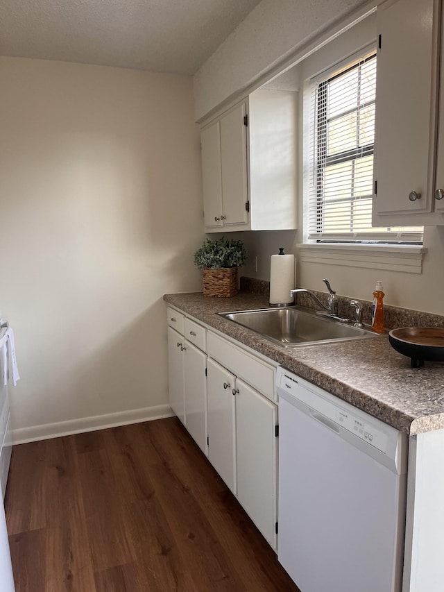 kitchen with white cabinetry, white dishwasher, dark hardwood / wood-style flooring, and sink