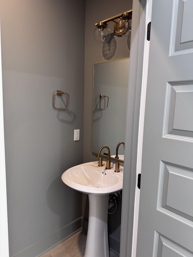 bathroom featuring baseboards and wood finished floors