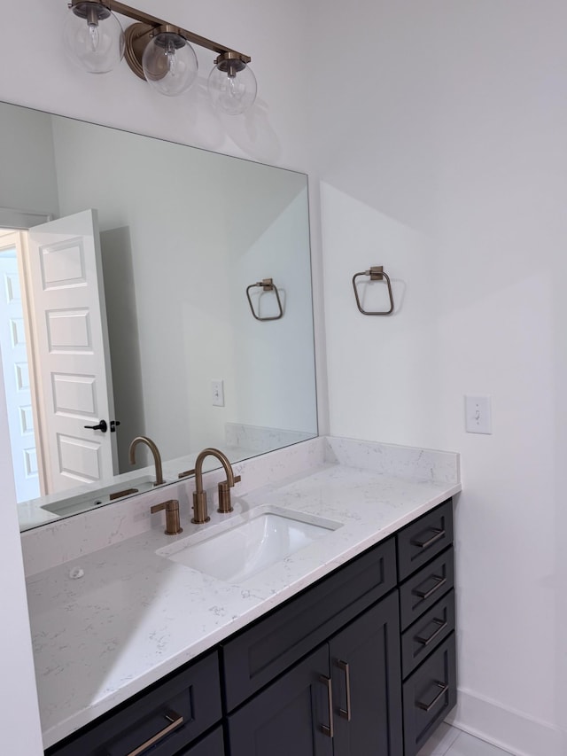 bathroom featuring baseboards and vanity