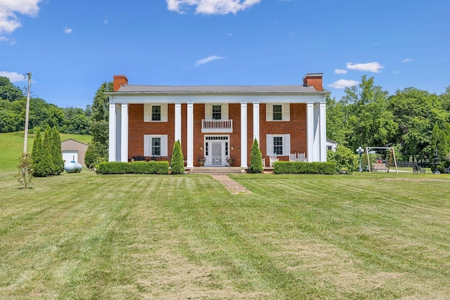 neoclassical home with a front yard