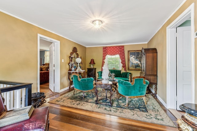 living room with hardwood / wood-style flooring and crown molding