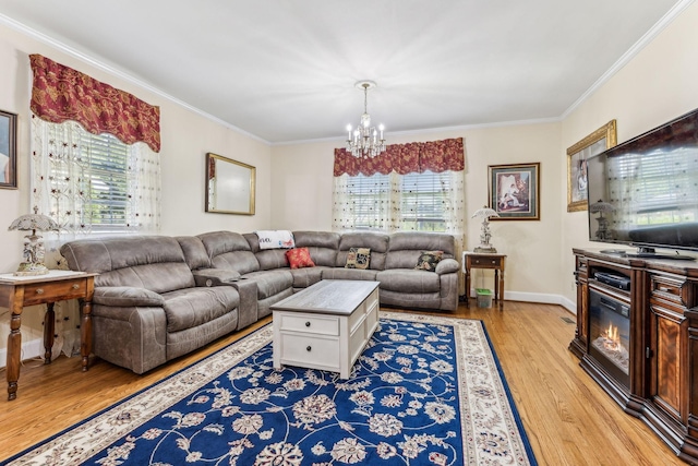 living room with light hardwood / wood-style flooring, a chandelier, and ornamental molding