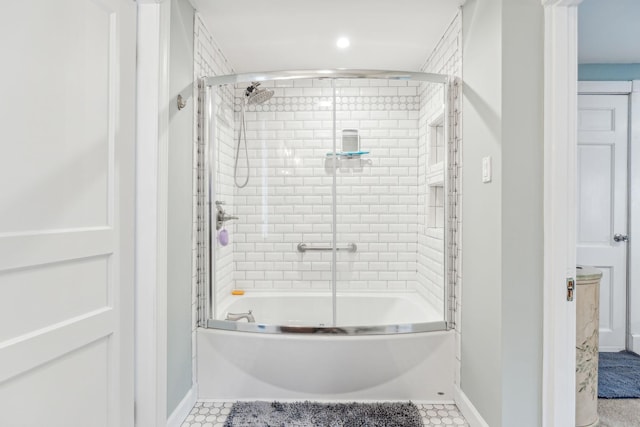 bathroom with shower / bath combination with glass door